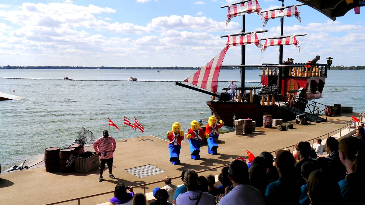 Ship in the lake and people watching the show Battle for Brickbeard’s Bounty at LegoLand Florida - Orlando, Florida, USA