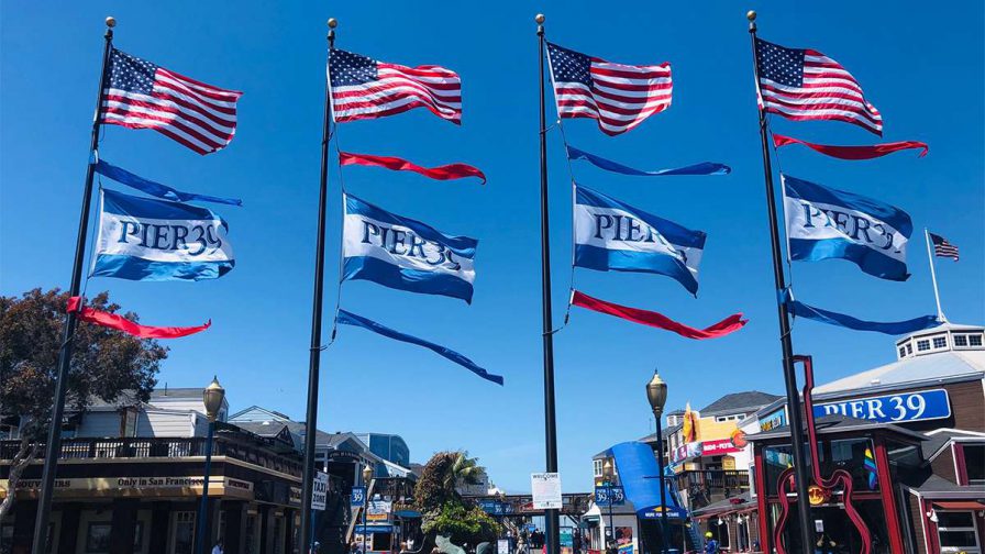 close up of navy and white Pier 39 flags on a sunny day in San Francisco, California, USA