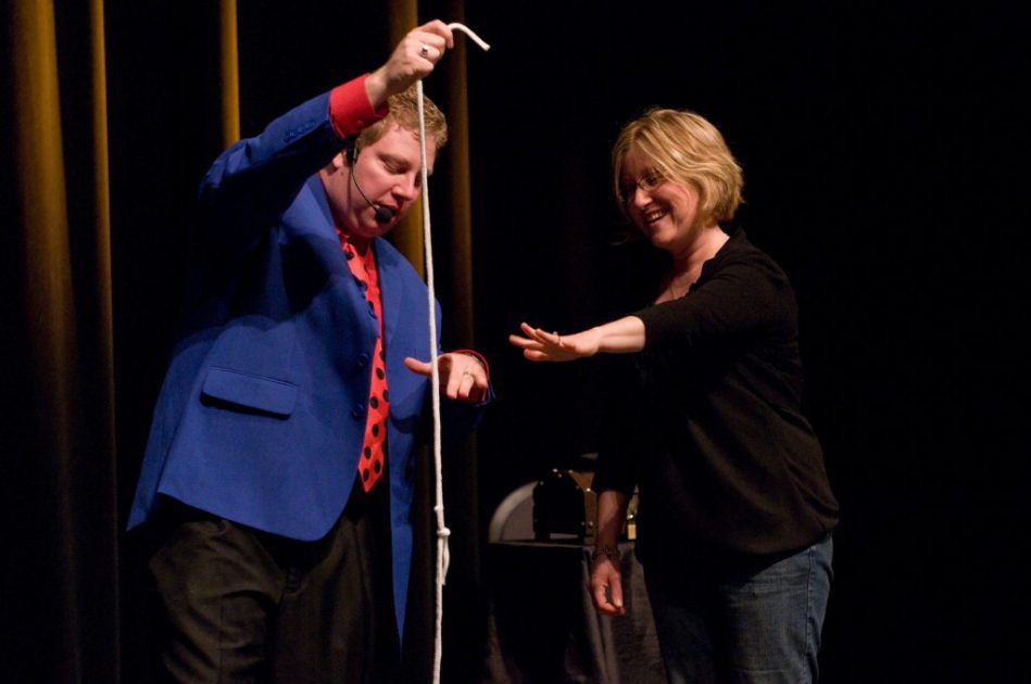 magician on stage with a rope and a woman at the Impossibilities: Magic, Mindreading and Mayhem in Gatlinburg, Tennessee, USA
