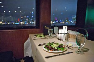 table set for dinner with outside view of water and skyline