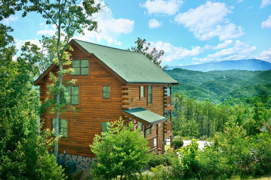 exterior view of Hearthside Cabin Rentals with Great Smoky Mountains in background in Pigeon Forge, Tennessee, USA
