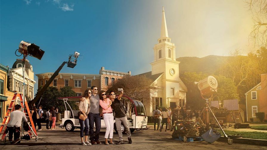 family posing with cameras at warner brothers studio tour in hollywood