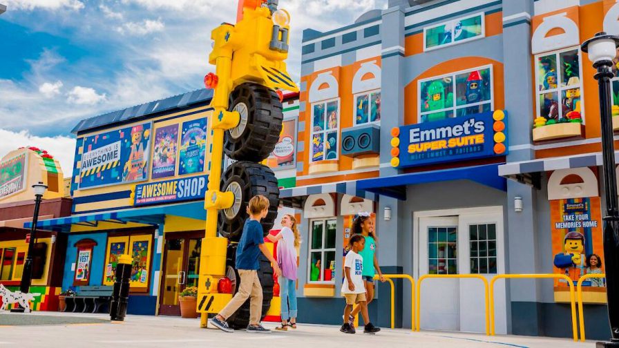 Kids walk towards the new Emmet's Super Suite apartment attraction in LEGOLAND California on a sunny day in Carlsbad, CA, USA