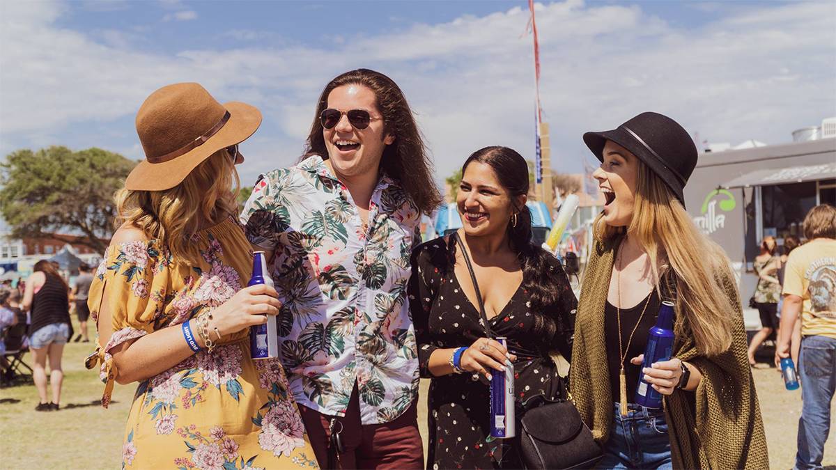 People smiling and drinking at the Myrtle Beach Food Truck Fest in Myrtle Beach, SC, USA