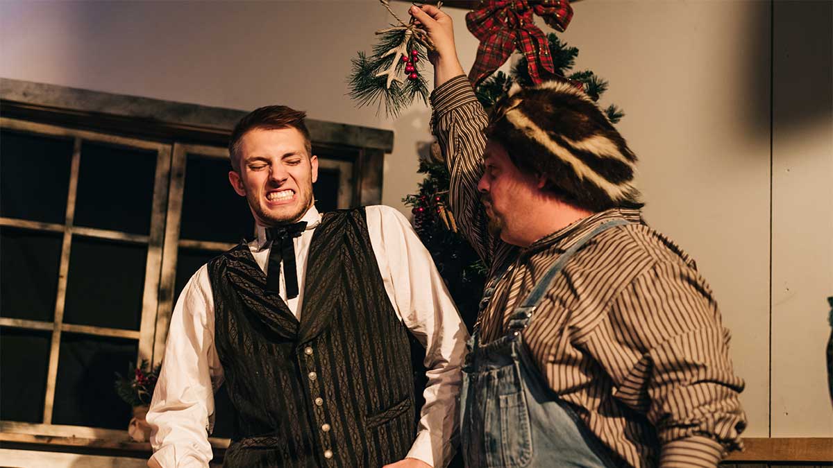 Two male actors with mistletoe in the Shepherd's Christmas Carol Dinner Show in Branson, Missouri, USA