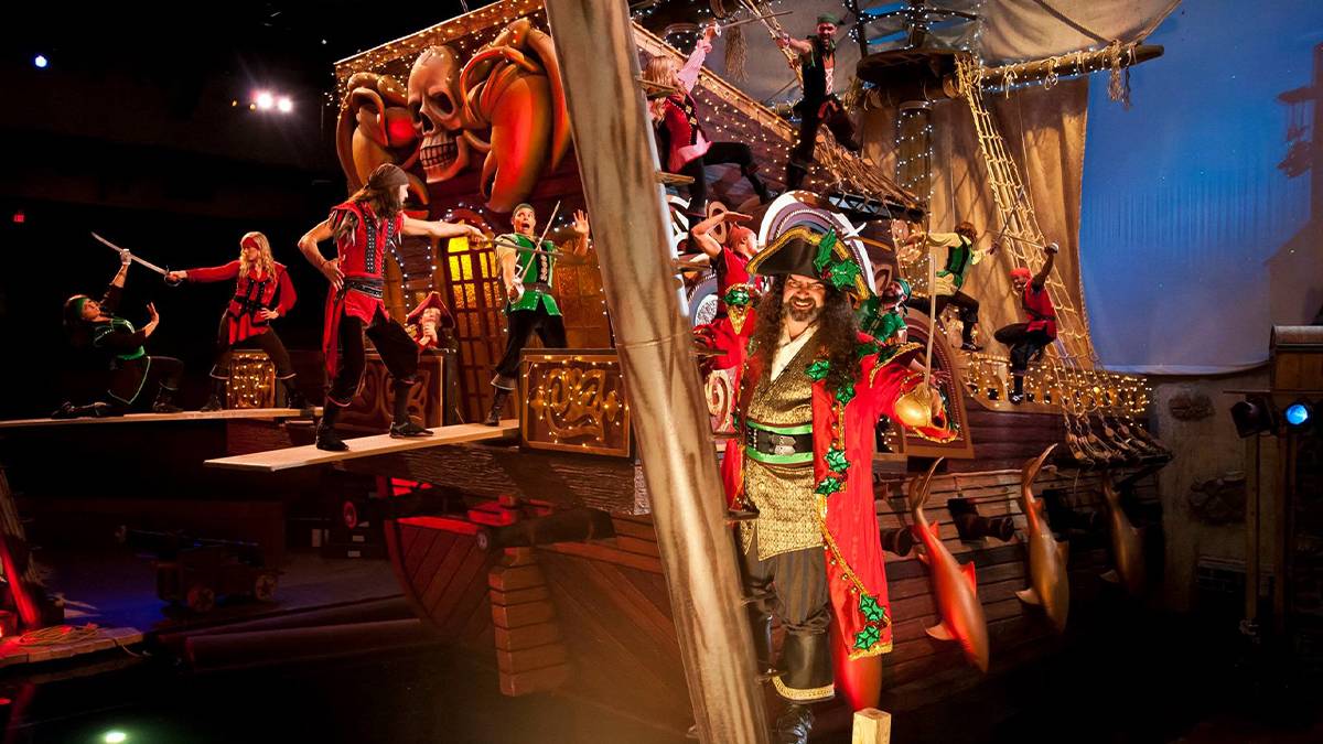 Group of pirates in bright outfits on a big wooden pirate ship at the Pirates Voyage Dinner and Show in Myrtle Beach, South Carolina, USA