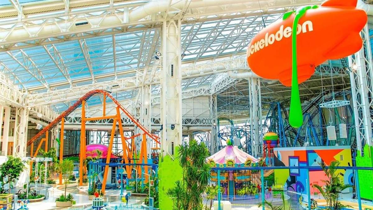 Wide shot overlooking the rides and other activities with the orange blimp overhead at Nickelodeon Universe in Rutherford, New Jersey, USA