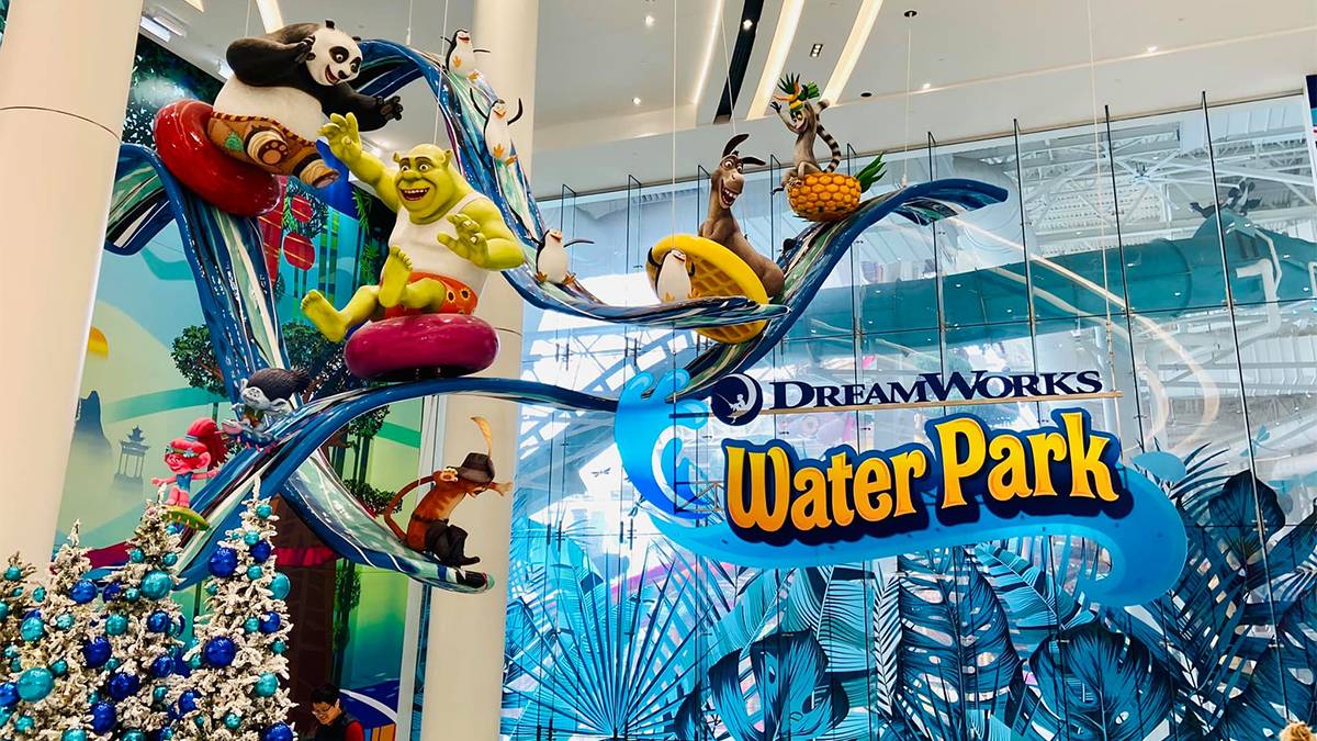 View of a sculpture with different DreamWorks characters riding waves hanging from the ceiling with a sign for DreamWorks Water Park next to it in Rutherford, New Jersey, USA
