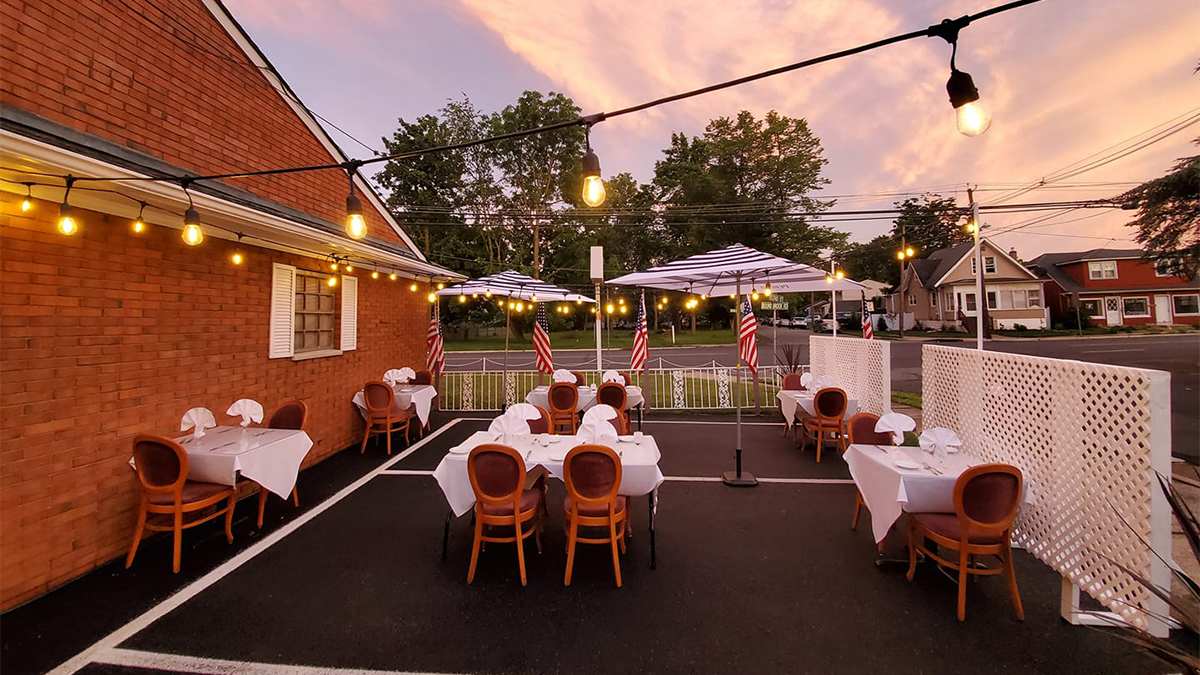View of the outdoor dining area at Carpaccio at sunset with string lights over head in Rutherford, New Jersey, USA