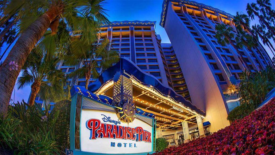 Close up view of the sign for Disney's Paradise Pier Hotel looking up at the hotel behind it in Los Angeles, California, USA