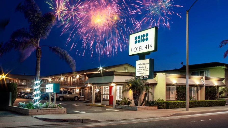 The Hotel 414 Anaheim at night with fireworks bursting overhead in Los Angeles, California, USA