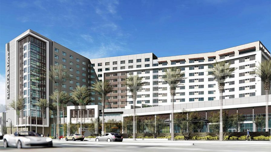 Straight on view of the JW Marriott Anaheim Resort with a bright blue sky behind it in Los Angeles, California, USA