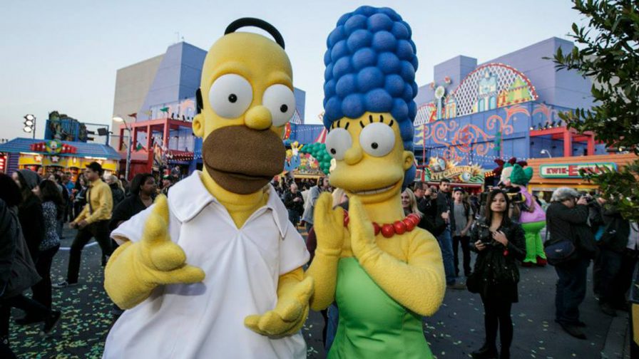 Close up photo of Marge and Homer Simpson with a crowd of people behind them at Universal Studios Hollywood in Los Angeles, California, USA