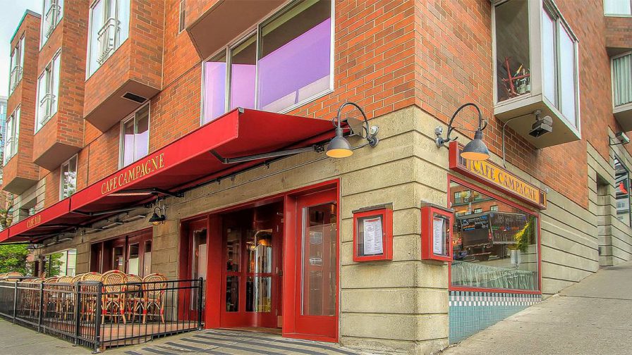 Exterior view of Cafe Campagne with its red doors and awning in Seattle, Washington, USA