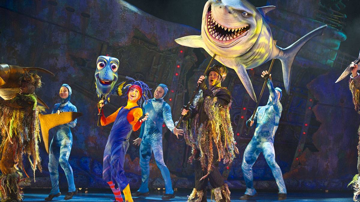 performers of the Finding Nemo: The Big Blue and Beyond! show on stage holding large puppets of various sea creatures in Disneyworld, Orlando, Florida, USA