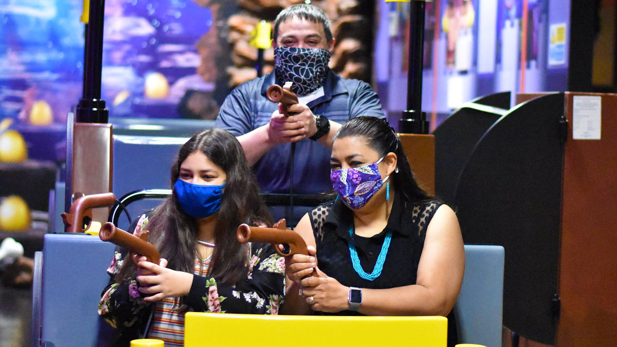 family on board interactive Kingdom Quest ride at Legoland San Antonio, Texas, USA