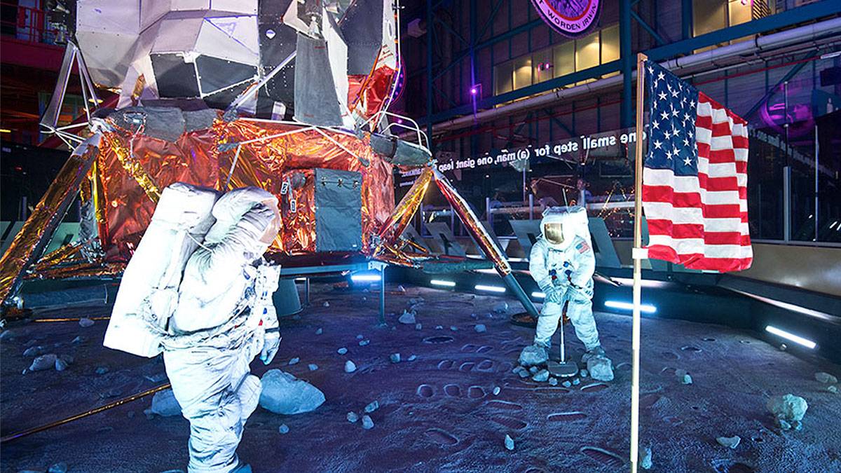 Moonscape exhibit with astronauts, spaceship, and american flag at Kennedy Space Center Visitor Center in Orlando, Florida, USA