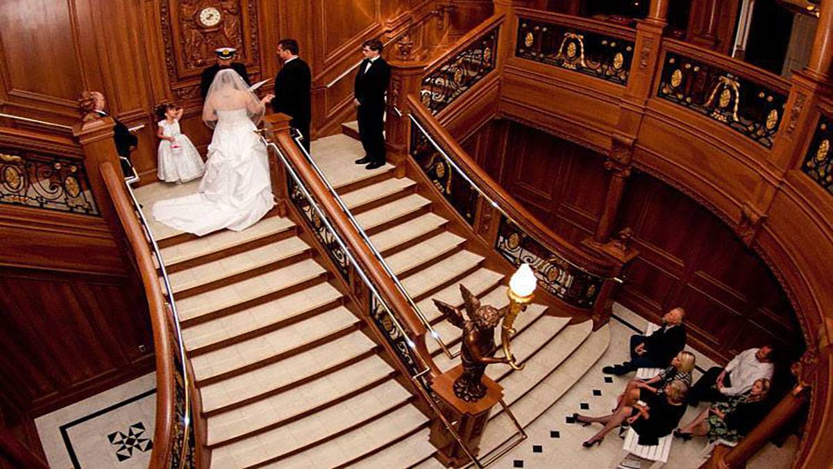 bride and groom on top of stairs reciting vows