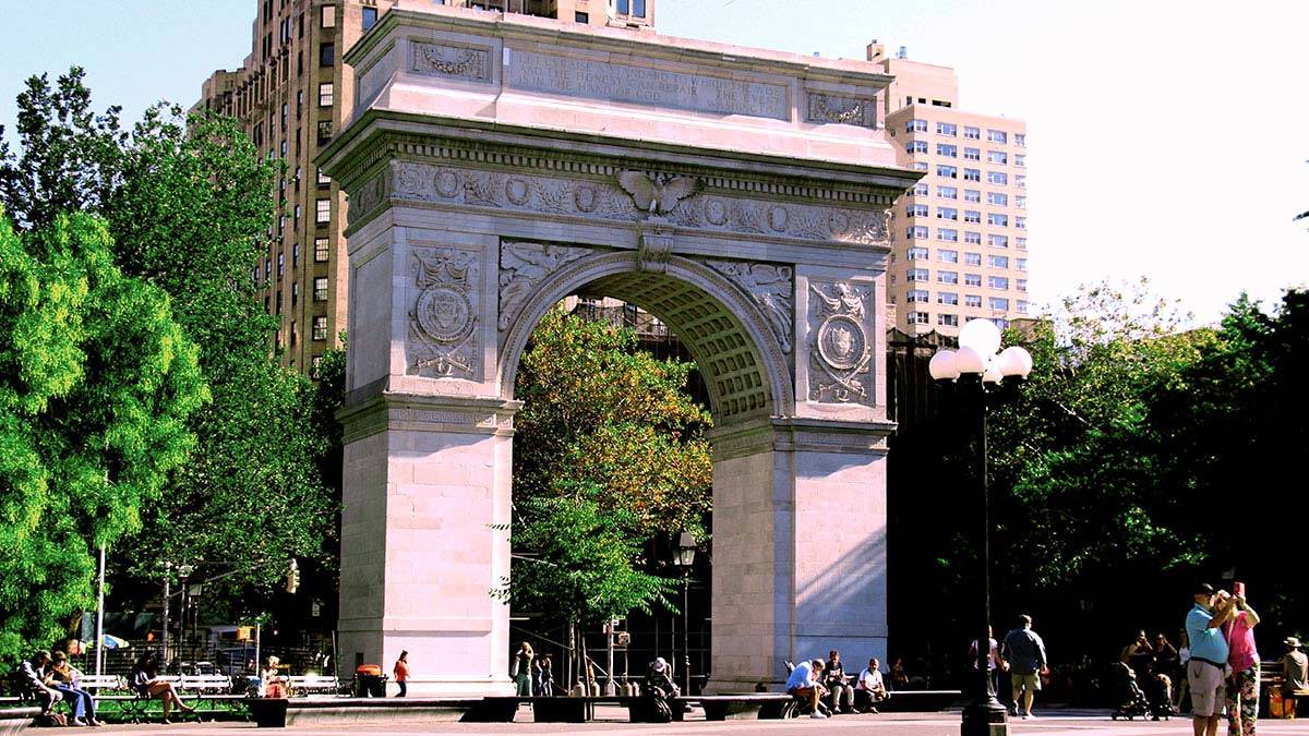 Washington Square Memorial Arch with people walking in Washington Square Park, New York City during daytime