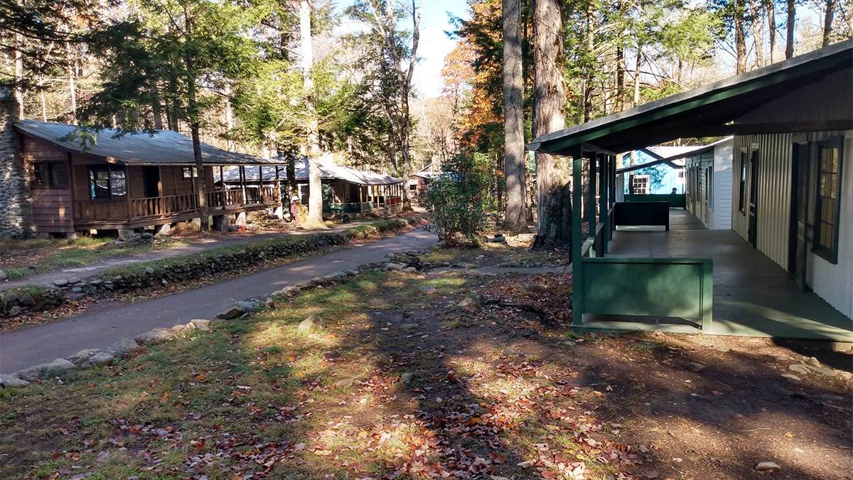 Wide shot of the empty cabins at Elkmont Ghost Town on a sunny day in Gatlinburg, Tennessee, USA