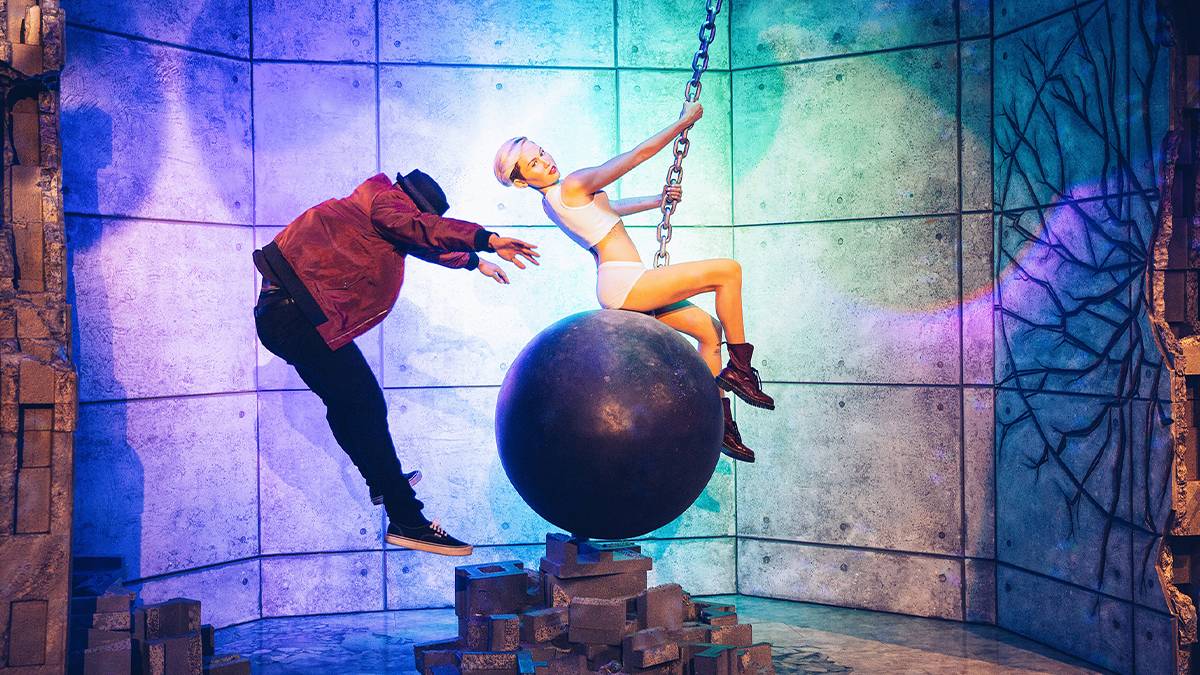 Wide shot of someone being blow away by the wax figure of Miley Cyrus on the wrecking ball at Madame Tussauds in Las Vegas, Nevada, USA