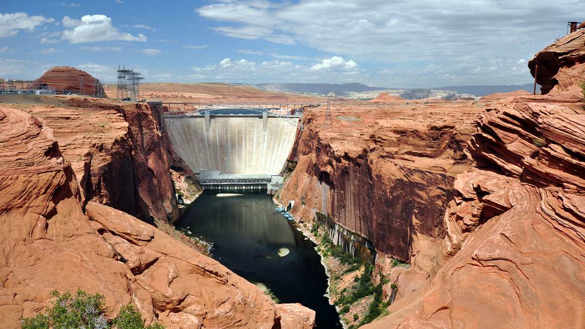View looking at the Hoover Dam from the surrounding rocks on a sunny day with clouds in the sky near Las Vegas, Nevada, USA