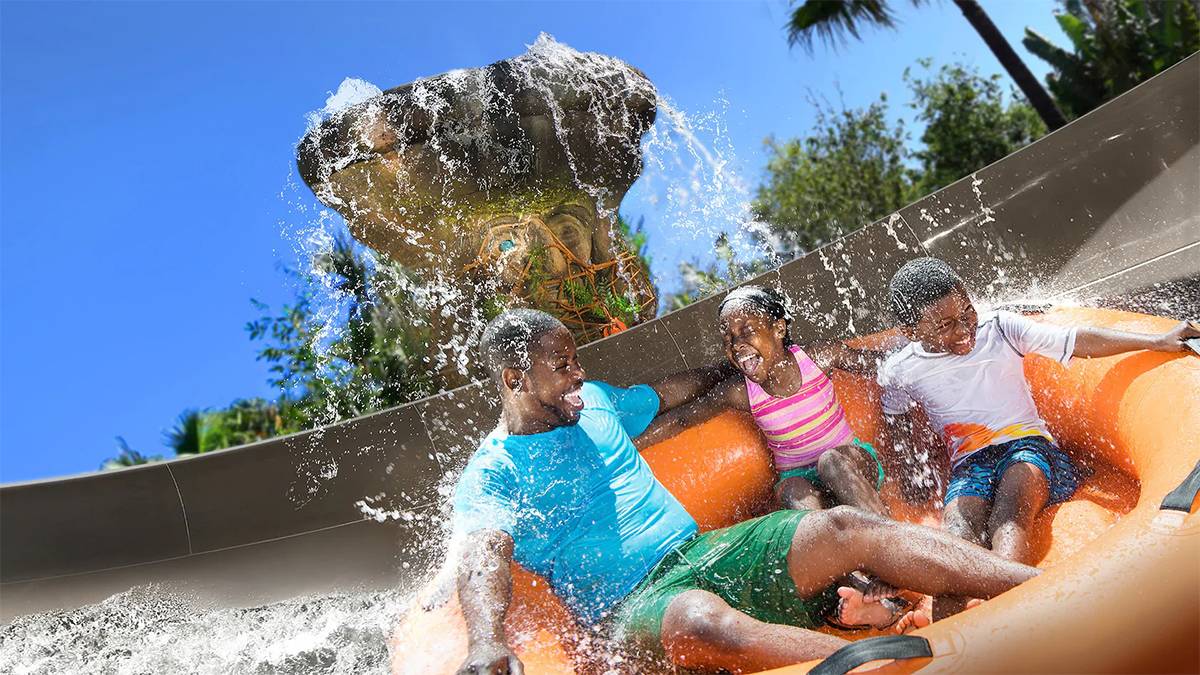 Close up of a family riding Miss Adventure Falls with water falling on their heads on a sunny day at Typhoon Lagoon in Orlando, Florida, USA